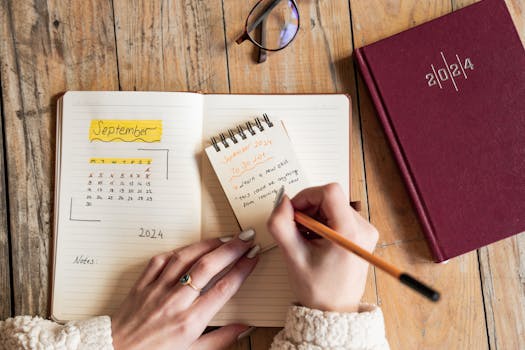 A close-up of a person writing a to-do list for September 2024 in a notepad.