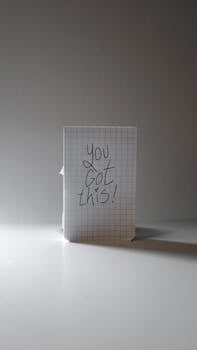 Close-up of a motivational message 'You Got This!' written on grid paper against a neutral background.