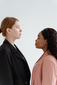 Two female leaders in business suits facing each other, symbolizing equality and empowerment.